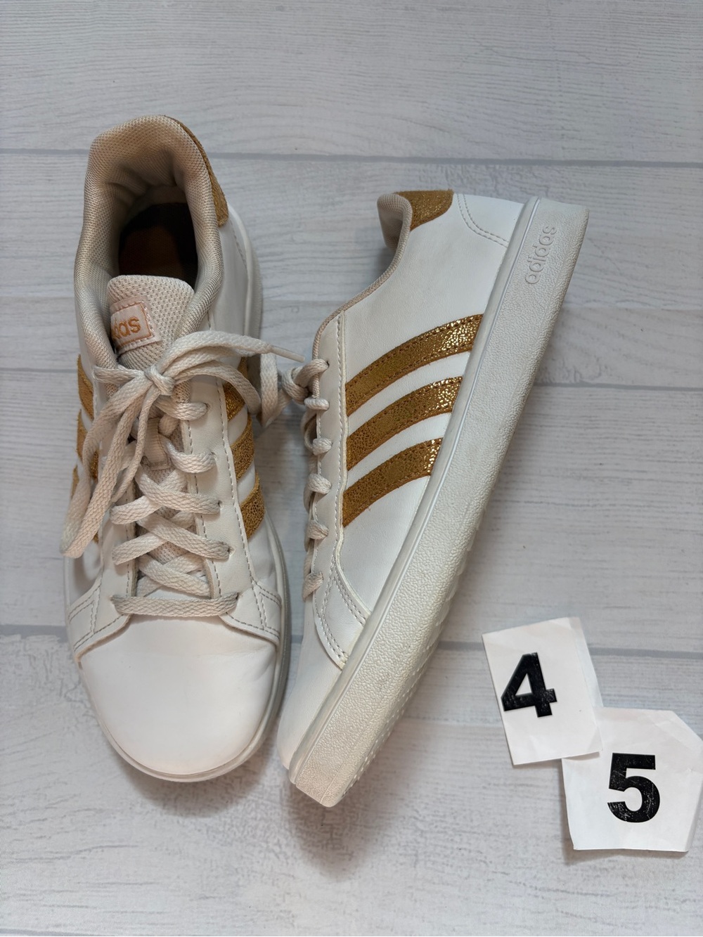 adidas White Sneakers with Gold Stripe Accents
